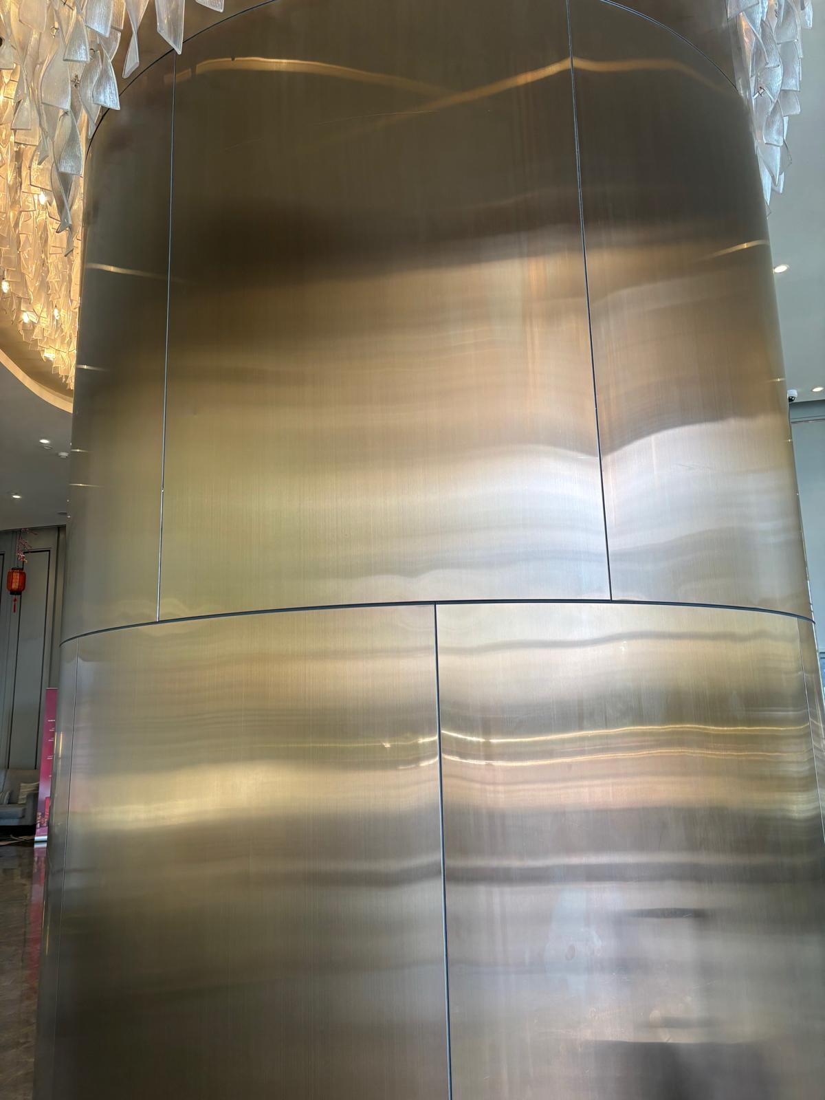 Brushed metal column cladding in luxury hotel lobby